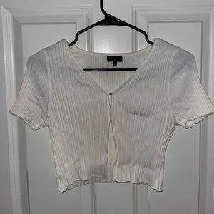White crop top with clips in the chest. Size S/M.
